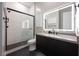 Contemporary bathroom featuring a glass-enclosed shower and a sleek vanity with an illuminated mirror at 333 Highview Ridge Ave, Las Vegas, NV 89138