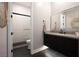 Modern bathroom featuring a floating vanity, large mirror, and a shower with sleek, dark hardware and textured tiling at 333 Highview Ridge Ave, Las Vegas, NV 89138