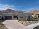 Modern home showcasing desert landscaping and mountain views under a bright, cloudy sky at 333 Highview Ridge Ave, Las Vegas, NV 89138