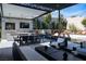 Sophisticated outdoor living area featuring a full kitchen, dining, lounge seating, and a tranquil water feature at 333 Highview Ridge Ave, Las Vegas, NV 89138