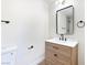 Bathroom with a wood vanity, white countertop, and a modern black mirror at 3339 Duece St, Las Vegas, NV 89121