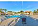 Inviting community pool surrounded by palm trees, seating, and lush landscaping at 3339 Duece St, Las Vegas, NV 89121