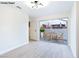 Bright living room with light floors, a modern light fixture, and access to a patio at 3339 Duece St, Las Vegas, NV 89121