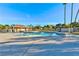 Community pool area with ample seating surrounded by palm trees and blue skies at 3339 Duece St, Las Vegas, NV 89121