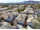 Stunning aerial view showcasing desert homes with tile roofs, complemented by a backdrop of majestic mountains at 3505 Tuscany Village Dr, Las Vegas, NV 89129