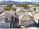 Bird's eye view of desert homes, showcasing their layout and design, under a bright blue sky at 3505 Tuscany Village Dr, Las Vegas, NV 89129