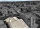 Aerial image capturing the charm of a neighborhood nestled amidst picturesque mountains and a clear blue sky at 3505 Tuscany Village Dr, Las Vegas, NV 89129