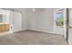 A bright bedroom features neutral carpeting, a barn-style door, and an exit to the back yard at 3505 Tuscany Village Dr, Las Vegas, NV 89129