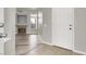 Entryway leading into a living room featuring a fireplace, gray walls and new flooring at 3505 Tuscany Village Dr, Las Vegas, NV 89129