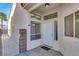 Welcoming front entrance features a gated courtyard with white stucco walls and large windows at 3505 Tuscany Village Dr, Las Vegas, NV 89129