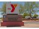 Durango Hills Golf Course sign, showcasing the golf course next to YMCA, surrounded by trees, and parked cars at 3505 Tuscany Village Dr, Las Vegas, NV 89129