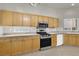 Spacious kitchen featuring wood cabinets, granite countertops, and stainless steel appliances at 3505 Tuscany Village Dr, Las Vegas, NV 89129