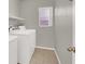 Laundry room features white washer and dryer, tile floors, and a window at 3505 Tuscany Village Dr, Las Vegas, NV 89129