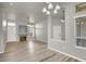 Open-concept living room with fireplace, new flooring, and abundant natural light at 3505 Tuscany Village Dr, Las Vegas, NV 89129