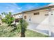 This outdoor space boasts a covered patio, complemented by green grass and lush landscaping at 3505 Tuscany Village Dr, Las Vegas, NV 89129