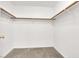Spacious walk-in closet features neutral carpeting and wood shelving for storage at 3505 Tuscany Village Dr, Las Vegas, NV 89129