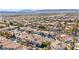 Expansive aerial view of a residential neighborhood with mountain backdrop and similar tile-roofed homes at 3620 Bahama Bay Ct, Las Vegas, NV 89147