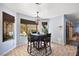 Bright dining area with large windows, chandelier, and a table set for four at 3620 Bahama Bay Ct, Las Vegas, NV 89147