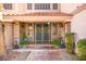 Charming front porch featuring stone columns, an iron gate, and meticulous desert landscaping at 3620 Bahama Bay Ct, Las Vegas, NV 89147