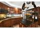 Well-equipped kitchen with a center island, stainless steel appliances, and dark wood cabinetry at 3620 Bahama Bay Ct, Las Vegas, NV 89147