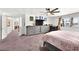 Bright and airy bedroom with plush carpeting, a ceiling fan, and a wall-mounted television at 3620 Bahama Bay Ct, Las Vegas, NV 89147