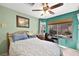 Bedroom featuring a large window with a view of the backyard pool and lush landscaping at 3620 Bahama Bay Ct, Las Vegas, NV 89147