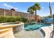 Backyard pool features a raised hot tub, rock waterfall, and lush landscaping at 3620 Bahama Bay Ct, Las Vegas, NV 89147