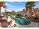 Backyard oasis with a custom pool featuring a waterfall and lush landscaping at 3620 Bahama Bay Ct, Las Vegas, NV 89147