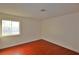 Bedroom featuring wood flooring, a window, and neutral color at 3630 Willow Springs Dr, Las Vegas, NV 89103