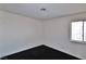 Corner view of bedroom featuring black carpet, a window, and neutral walls at 3630 Willow Springs Dr, Las Vegas, NV 89103