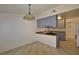 Open kitchen design featuring tile floors, a peninsula counter, and ample natural light at 3630 Willow Springs Dr, Las Vegas, NV 89103