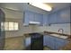 Functional kitchen with granite countertops, black appliances, and tile flooring at 3630 Willow Springs Dr, Las Vegas, NV 89103