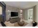 Living room with modern media center, neutral-toned furniture, and a view to a bathroom at 3722 Las Vegas Blvd # 1712, Las Vegas, NV 89158