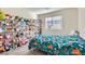 Whimsical bedroom with fun decor, a comfortable bed, and natural light at 3772 Brilliant Sunset St, Las Vegas, NV 89129