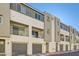 View of modern townhomes featuring garages, balconies, and neutral-toned stucco at 3772 Brilliant Sunset St, Las Vegas, NV 89129