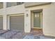 A front entrance with gray garage door, sage door, and red brick pathway at 3772 Brilliant Sunset St, Las Vegas, NV 89129