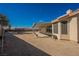 Expansive backyard featuring a covered patio, perfect for outdoor entertaining and relaxation in a desert landscape at 4016 Fairport Dr, North Las Vegas, NV 89032