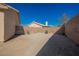 Backyard featuring a large dirt area, patio area, and brick wall at 4016 Fairport Dr, North Las Vegas, NV 89032