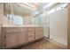 Bathroom features a double vanity sink, large mirror, and walk-in shower with glass doors at 4016 Fairport Dr, North Las Vegas, NV 89032