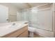 Bathroom featuring a single sink vanity and a bathtub with glass door at 4016 Fairport Dr, North Las Vegas, NV 89032