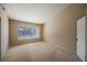 Bedroom with vaulted ceiling, neutral walls, carpeted floors, and window letting in natural light at 4016 Fairport Dr, North Las Vegas, NV 89032