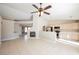 Open-concept living room and kitchen area with tile flooring, fireplace, and vaulted ceilings at 4016 Fairport Dr, North Las Vegas, NV 89032