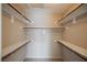 Walk-in closet with built-in shelving and wooden rods for ample storage at 4016 Fairport Dr, North Las Vegas, NV 89032