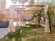 Backyard pergola with stylish privacy curtains and hammock nestled among the palms at 425 Donner Pass Dr, Henderson, NV 89014