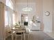 Cozy dining area with a modern chandelier and natural light from the window at 425 Donner Pass Dr, Henderson, NV 89014