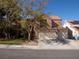 A two-story stucco home with a red tile roof and a three-car garage at 425 Donner Pass Dr, Henderson, NV 89014