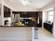 Well-equipped kitchen featuring stainless steel appliances and dark wood cabinets at 425 Donner Pass Dr, Henderson, NV 89014