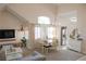 Inviting living room featuring high ceilings, a dining area, and a view into the kitchen at 425 Donner Pass Dr, Henderson, NV 89014