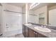 Bathroom features double sinks, granite countertops, and a shower over the tub at 4542 Townwall St, Las Vegas, NV 89115