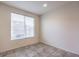 Bedroom features neutral tile floors and a large window providing natural light at 4542 Townwall St, Las Vegas, NV 89115